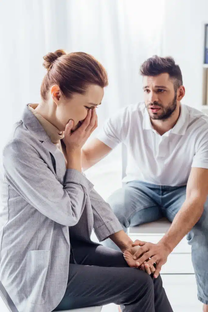 man consoling crying woman during therapy meeting 2023 11 27 05 15 28 utc