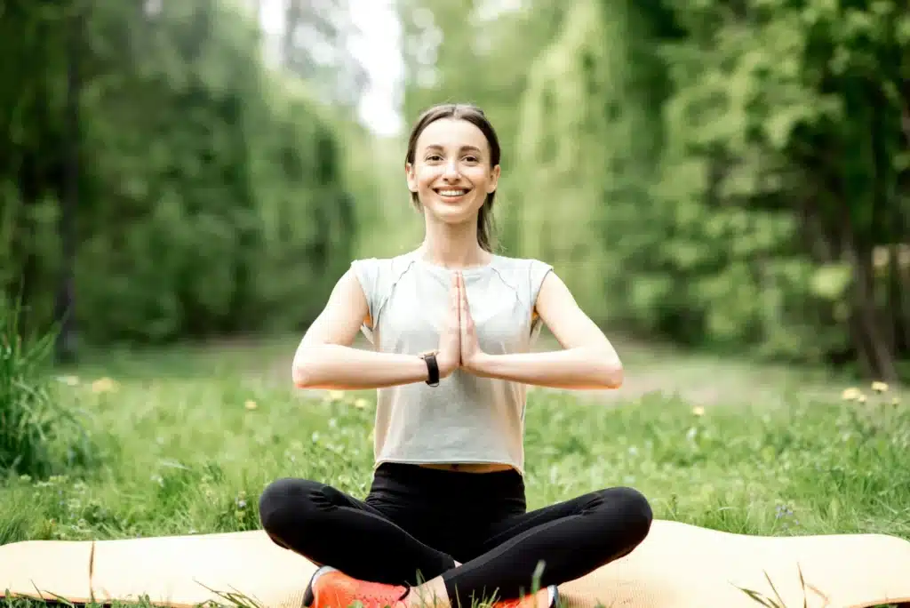 Young woman doing yoga in the park