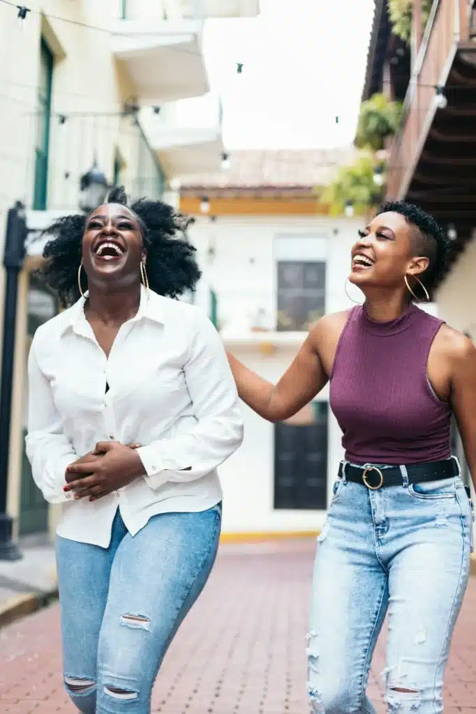 African american women laughing and having fun walking in the city