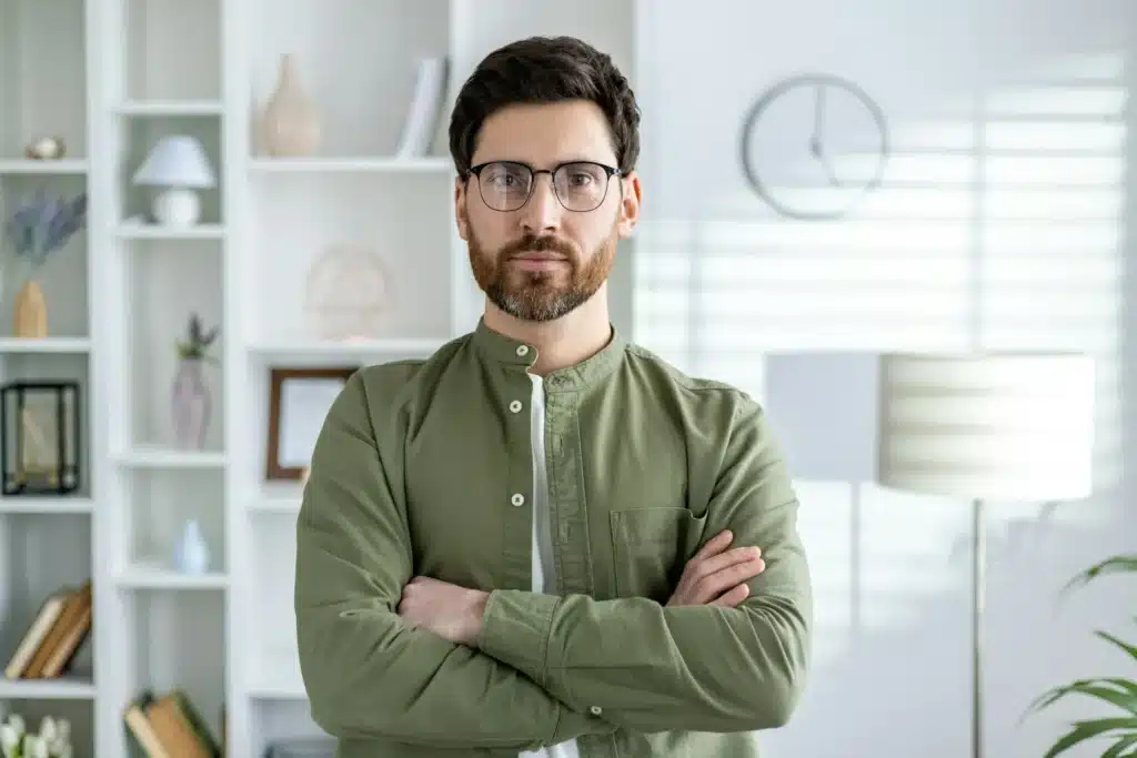 Confident professional man standing in a modern office