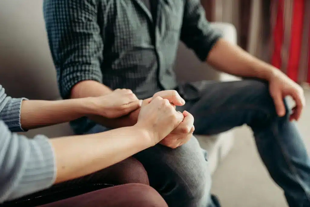 Couple hold hands, family psychology support