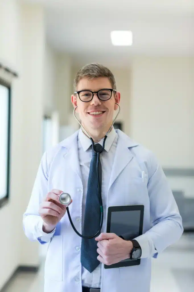 Doctor at hospital. Friendly doctor dressed in uniform with stethoscope.