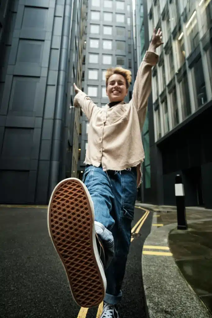 Exaggerated view of young woman showing euphoria in the street.