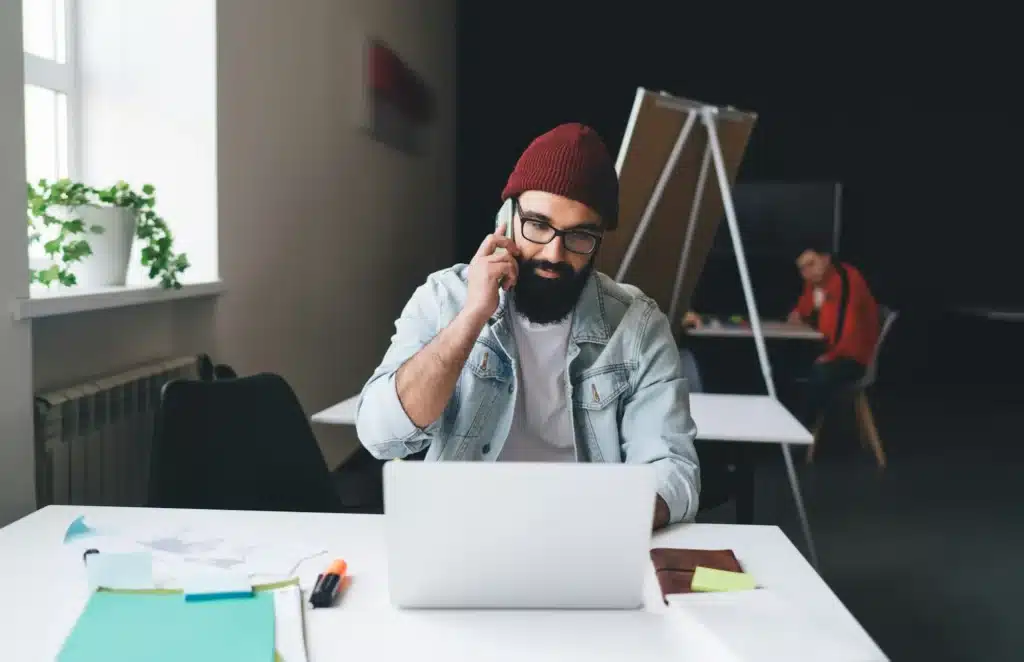 Focused businessman calling on smartphone in office