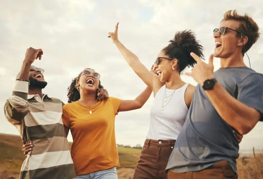 Friends, freedom and fun with a man and woman group laughing or joking while on summer vacation in