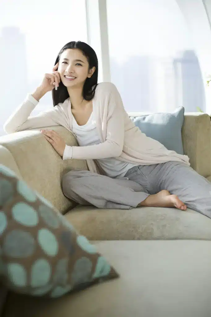 Happy young woman talking on cell phone