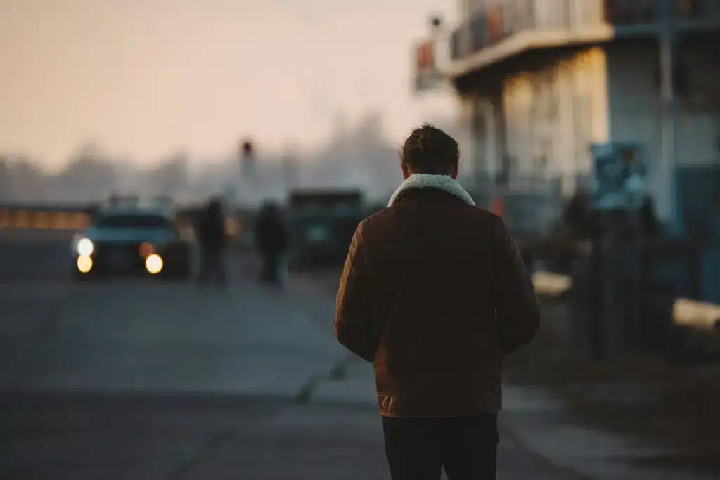 person walking in a dangerous neighborhood at evening