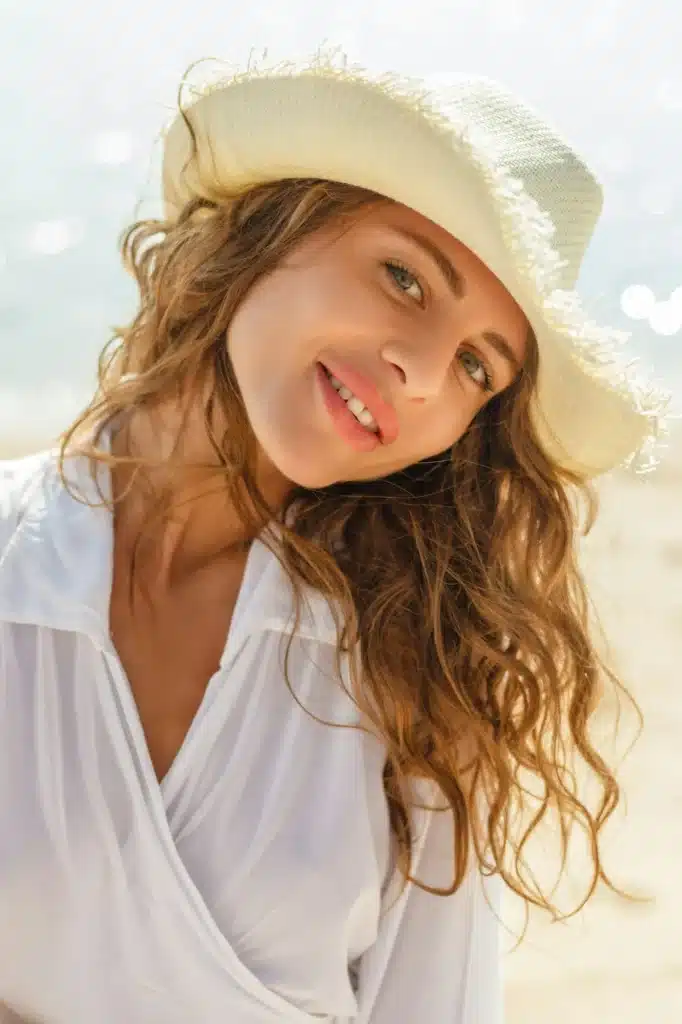 portrait of beautiful smiling girl in hat on resort