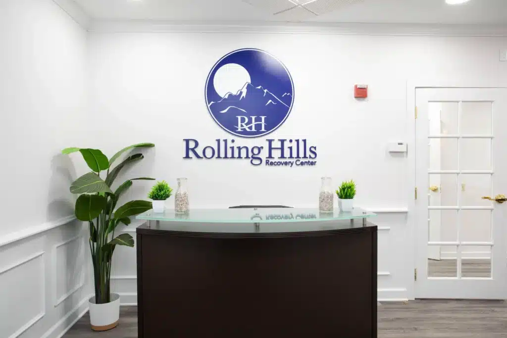 rolling hills recovery center front desk and logo on the wall.