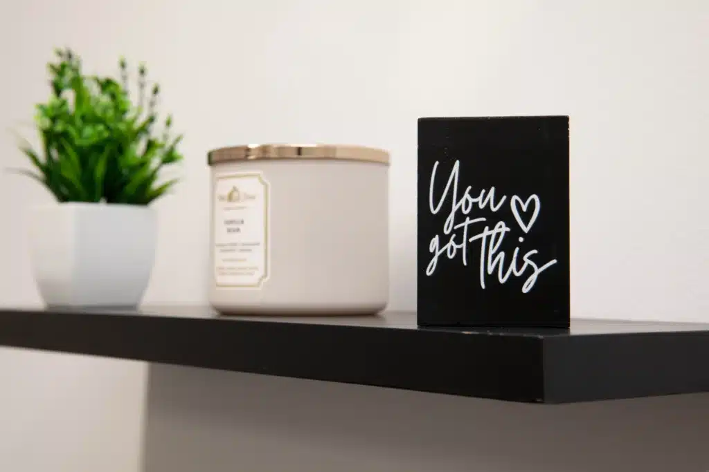 picture of a candle on a shelf at rolling hills and a slogan saying you got this.