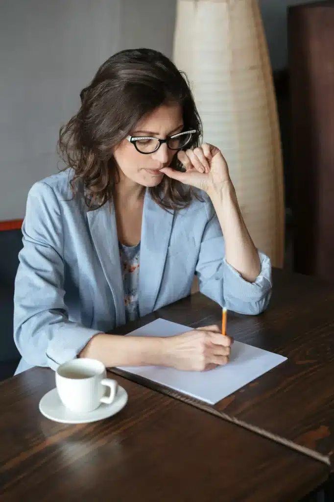 Thinking woman writer sitting indoors