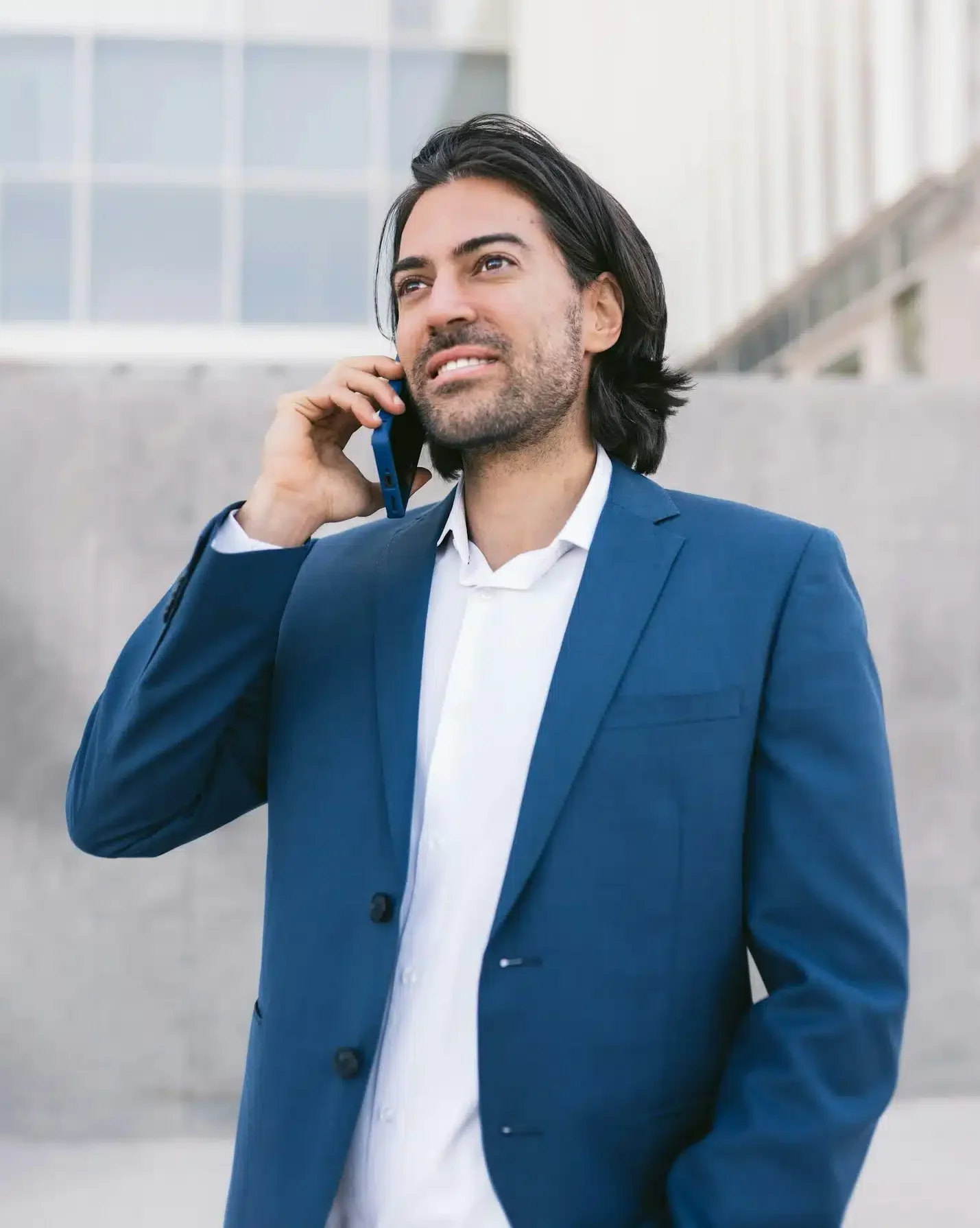 vertical image of smiling handsome Businessman having a Conversation on Smartphone out of office