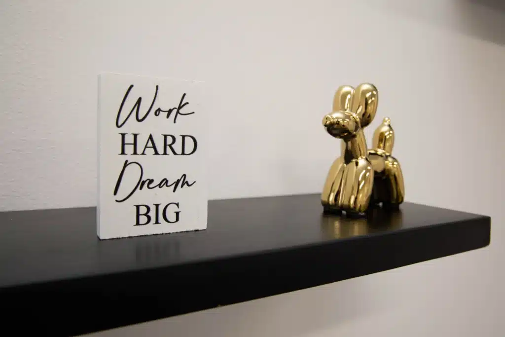 Wooden sign that says work hard dream big