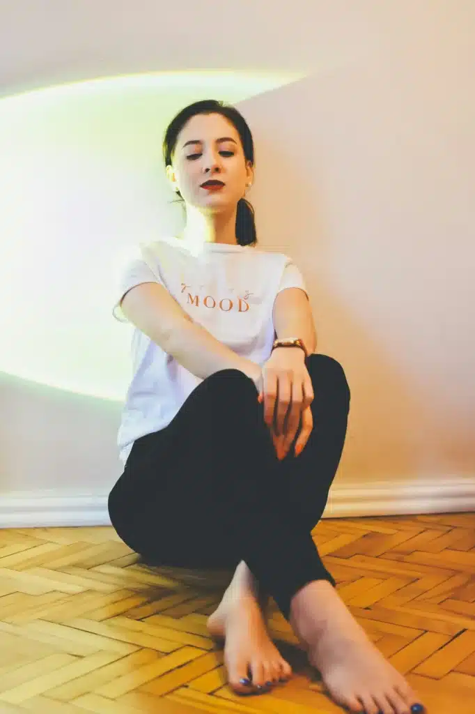 Young woman sitting on floor