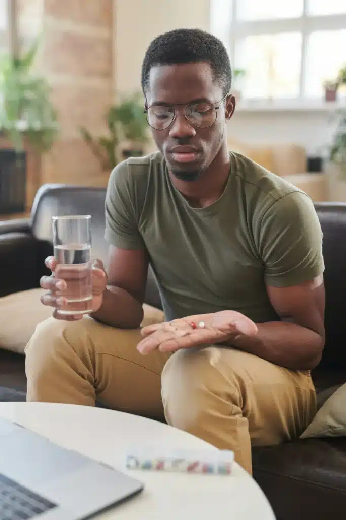 Young Man Taking Medicaments