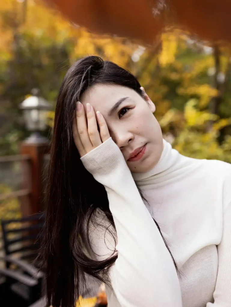 Candid portrait of beautiful Young stylish asian woman relaxing in modern outdoor cafe at Autumn