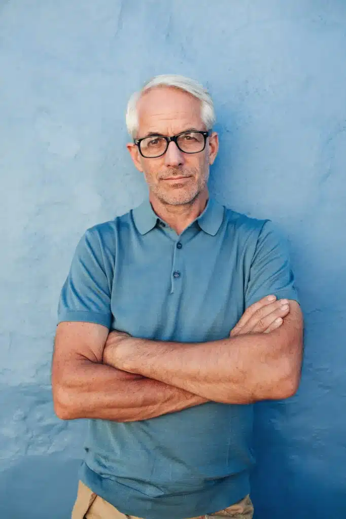 Caucasian man wearing glasses staring at camera