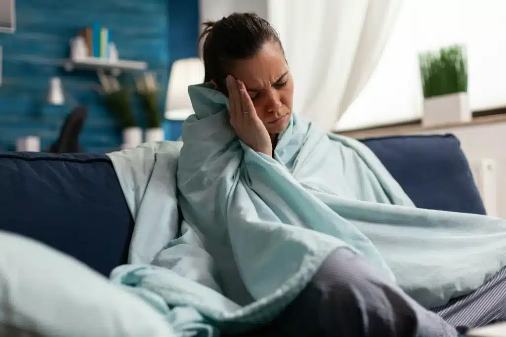 Caucasian woman feeling sick at home with headache