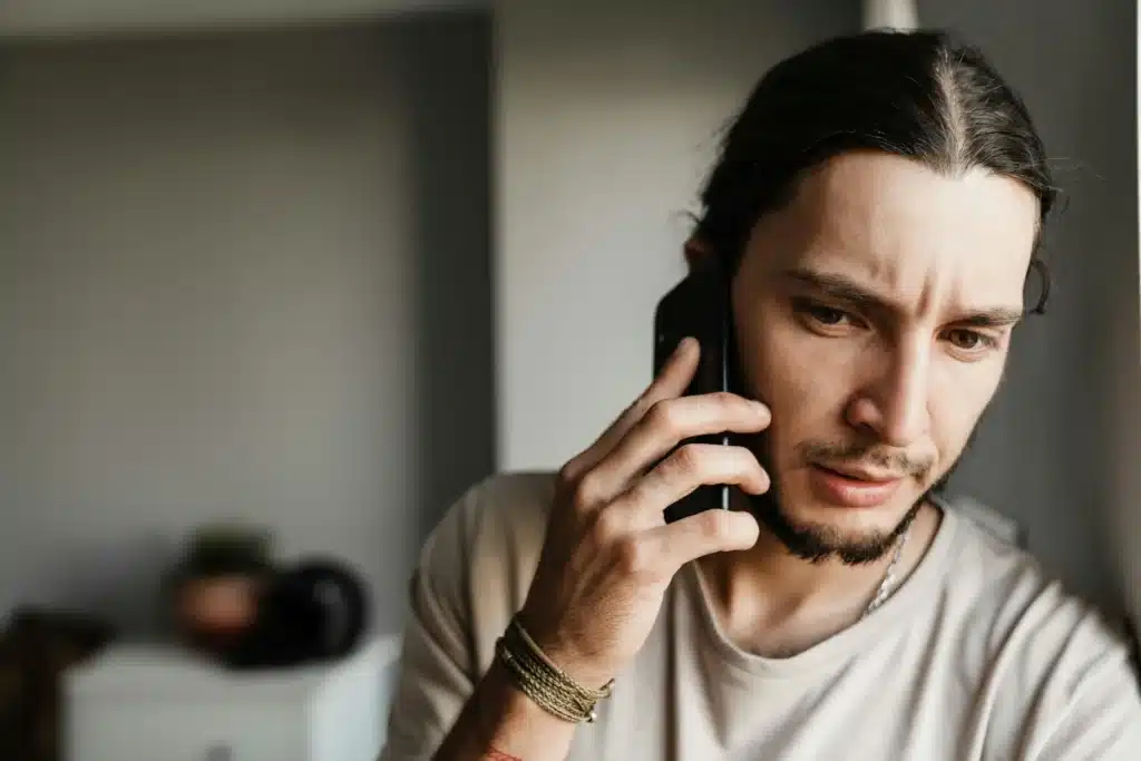 Close up of a concerned mman talking on mobile phone